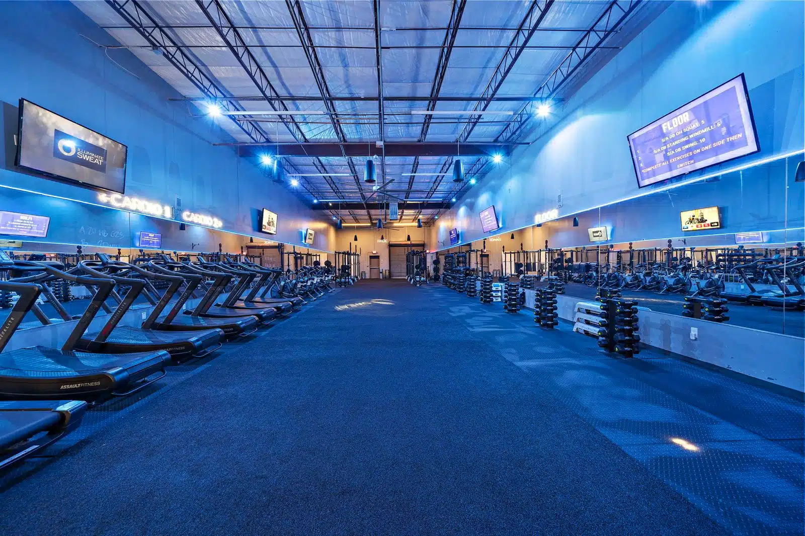 What is the difference between the morning and evening training groups at Illuminate Sweat Fitness?